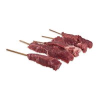 5 skewers of raw bison meat on white background