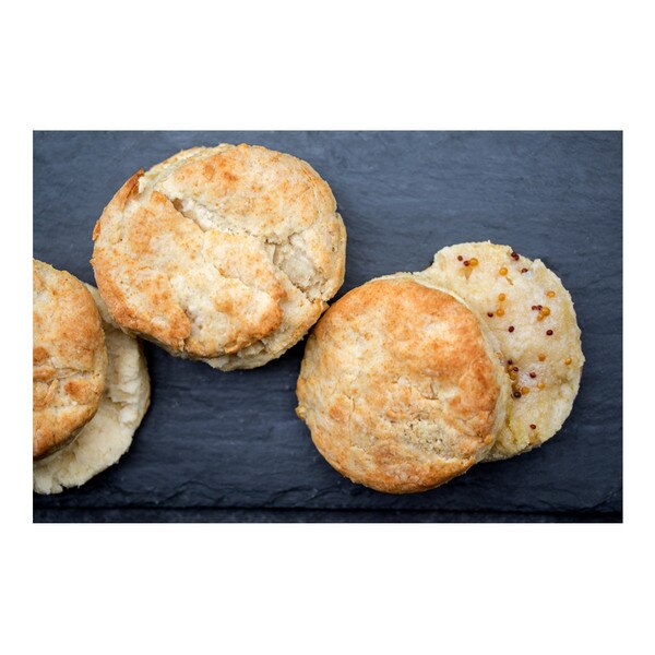 Three round split biscuits speckled with mustard seeds baked in Iberico pork back fat